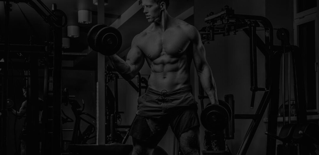Athlete performing a dumbbell curl in a gym to show Serious Supplements For Serious Performance