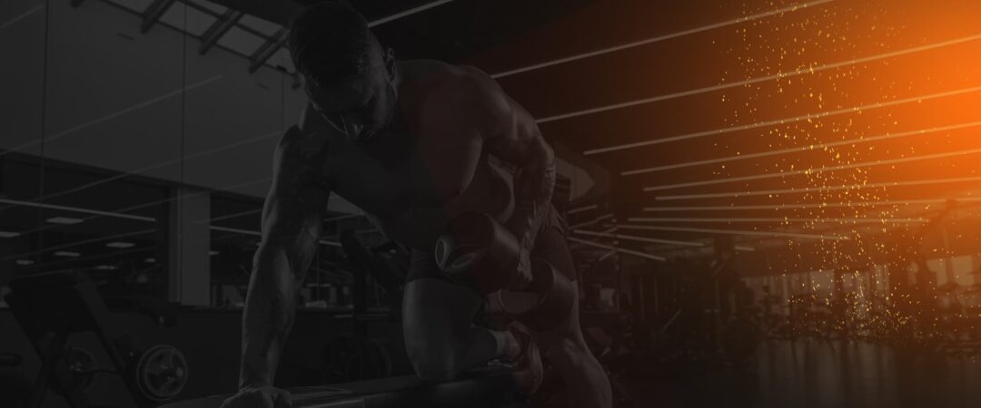 Bodybuilder performing a dumbbell row in a dimly lit gym to show Serious Supplements For Serious Performance